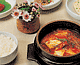 흰쌀밥과 뚝배기 그릇에 담겨진 붉은빛의 김치찌개 한상차림
